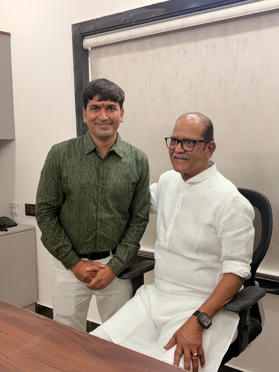 A portrait of hospital leadership with a guest inside Sanjeevi Hospital.