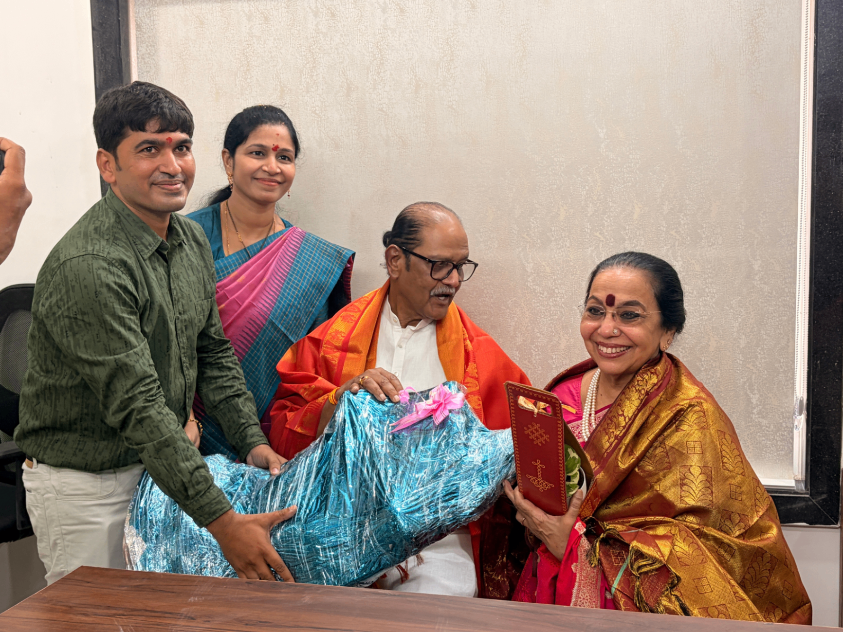 A ceremonial presentation moment with guests during the Sanjeevi Hospital inauguration.
