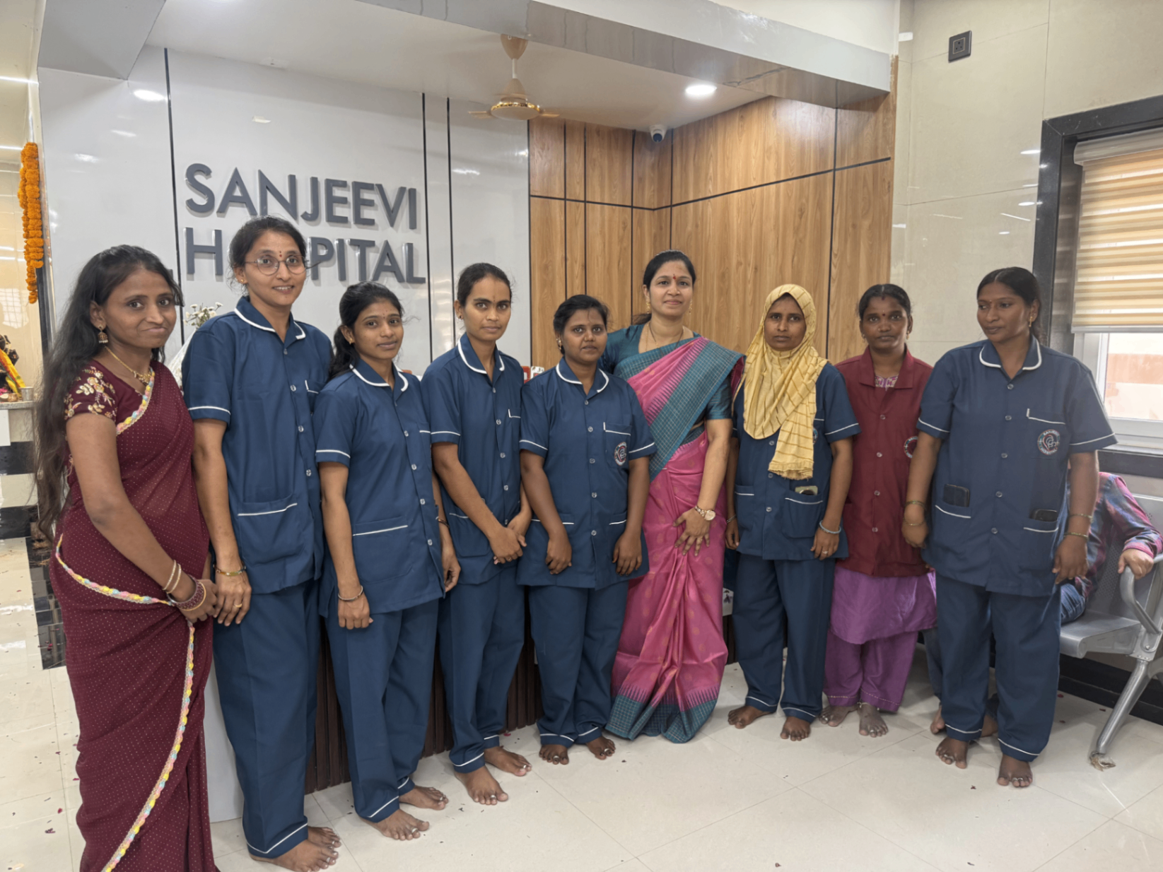 Sanjeevi Hospital nursing and support team posing together indoors.